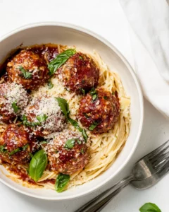 Homemade Baked Chicken Parmesan Meatballs with Roasted Garlic Spaghetti. recipe photo
